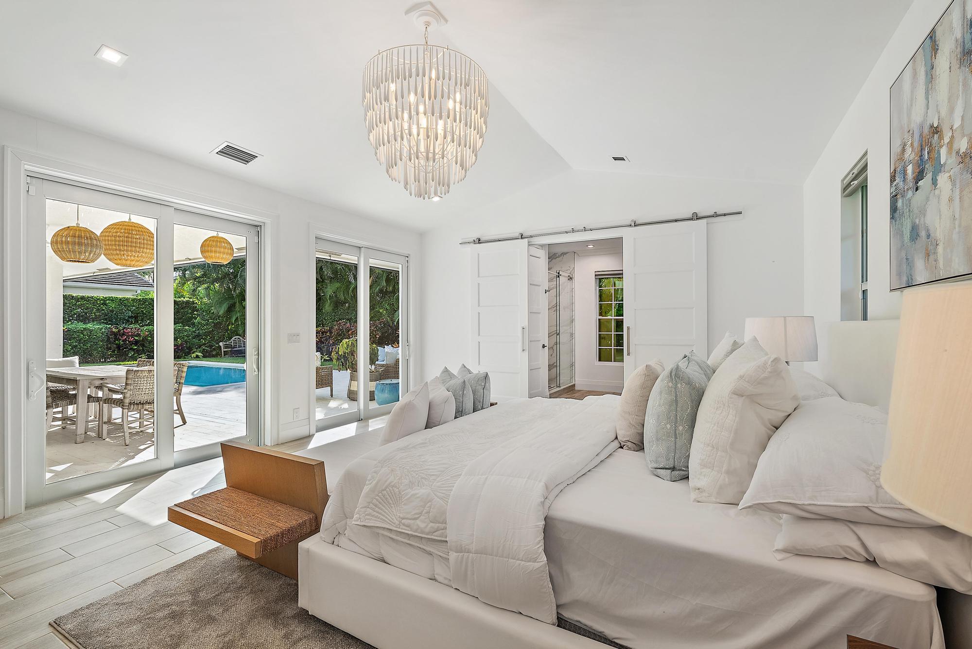 189 Shelter Lane Jupiter Inlet Colony, FL 33469 - Photo 22 of 48 a spacious bedroom with a bed and a large window