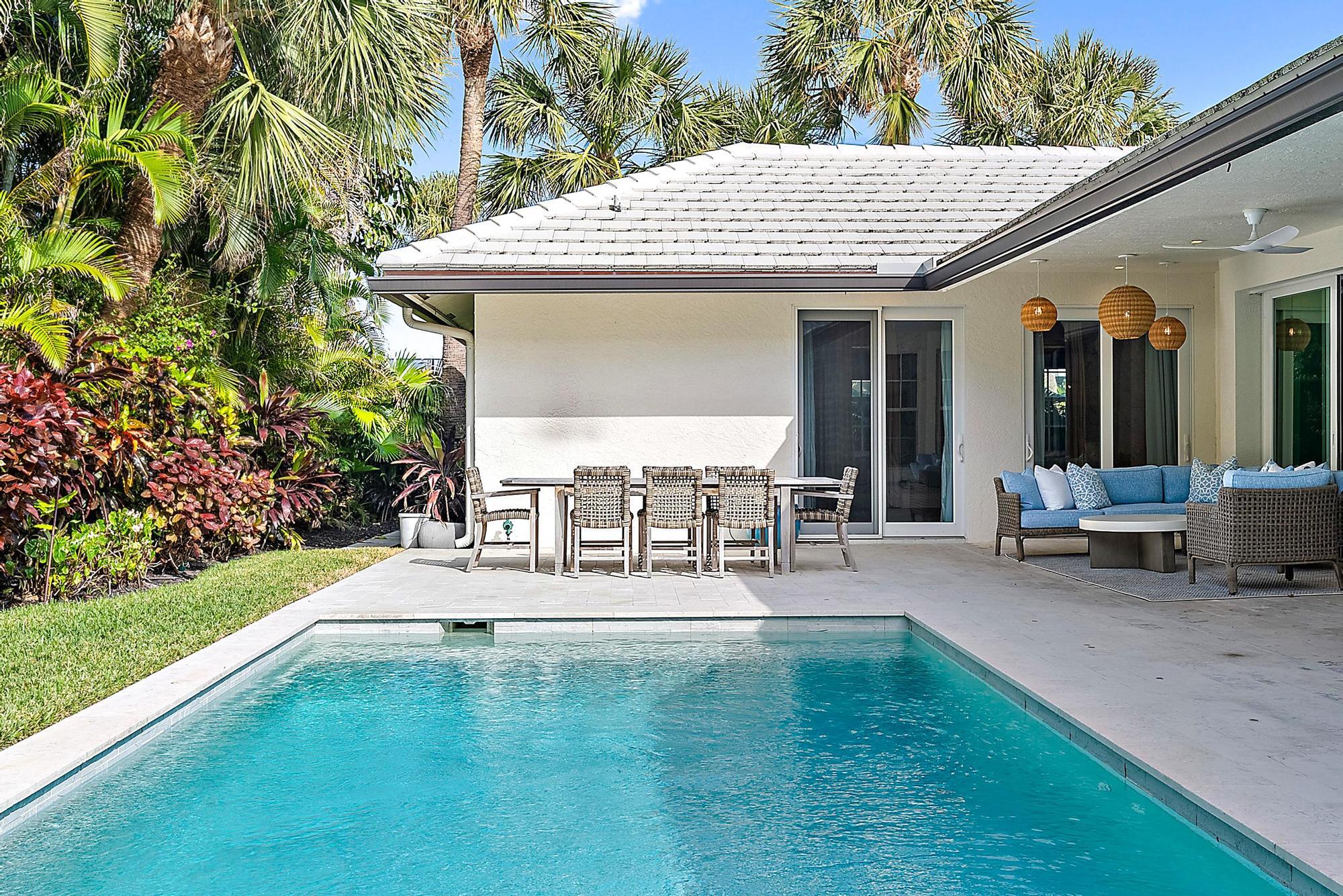 189 Shelter Lane Jupiter Inlet Colony, FL 33469 - Photo 37 of 48 a view of a patio with chairs and table in a patio