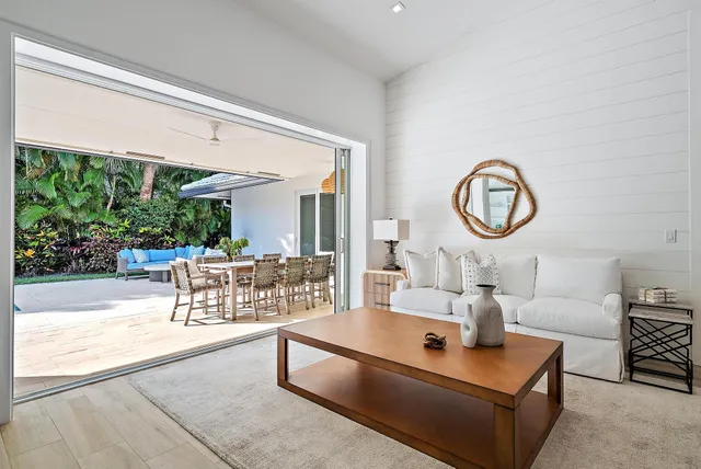 a kitchen with stainless steel appliances granite countertop a sink a stove top oven a chimney and a center island