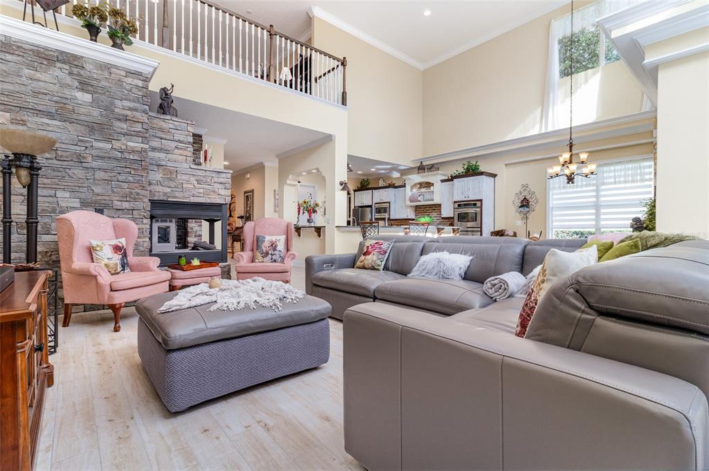404 Long And Winding Road Howey-in-the-Hills, FL 34737 - Photo 11 of 48 a living room with furniture and a fireplace