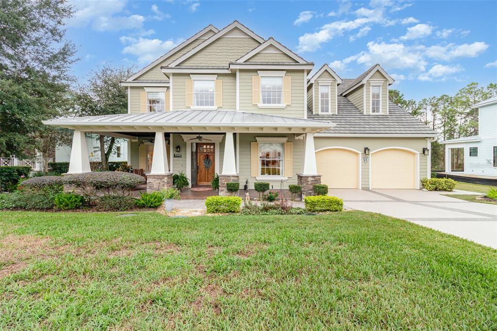 404 Long And Winding Road Howey-in-the-Hills, FL 34737 - Photo 2 of 48 a front view of a house with yard and green space