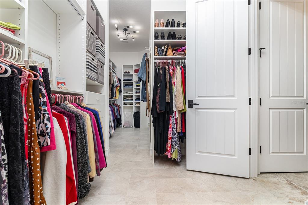 404 Long And Winding Road Howey-in-the-Hills, FL 34737 - Photo 22 of 48 a view of walk in closet with clothes