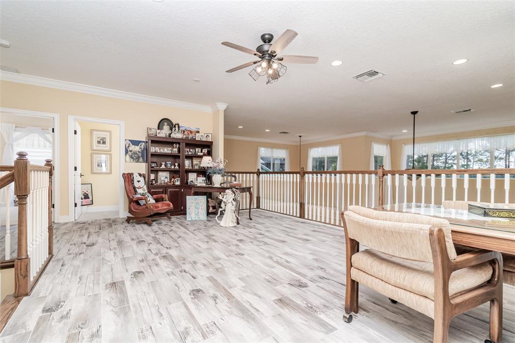 404 Long And Winding Road Howey-in-the-Hills, FL 34737 - Photo 30 of 48 a view of a livingroom with furniture and a ceiling fan