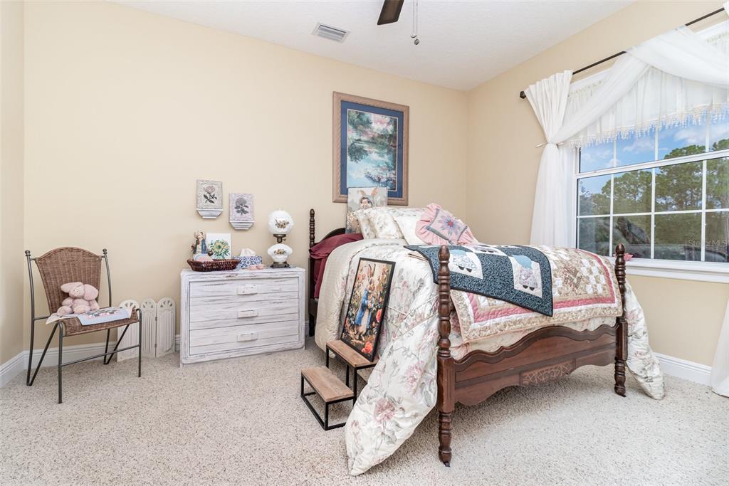 404 Long And Winding Road Howey-in-the-Hills, FL 34737 - Photo 32 of 48 a bedroom with a bed and a chair