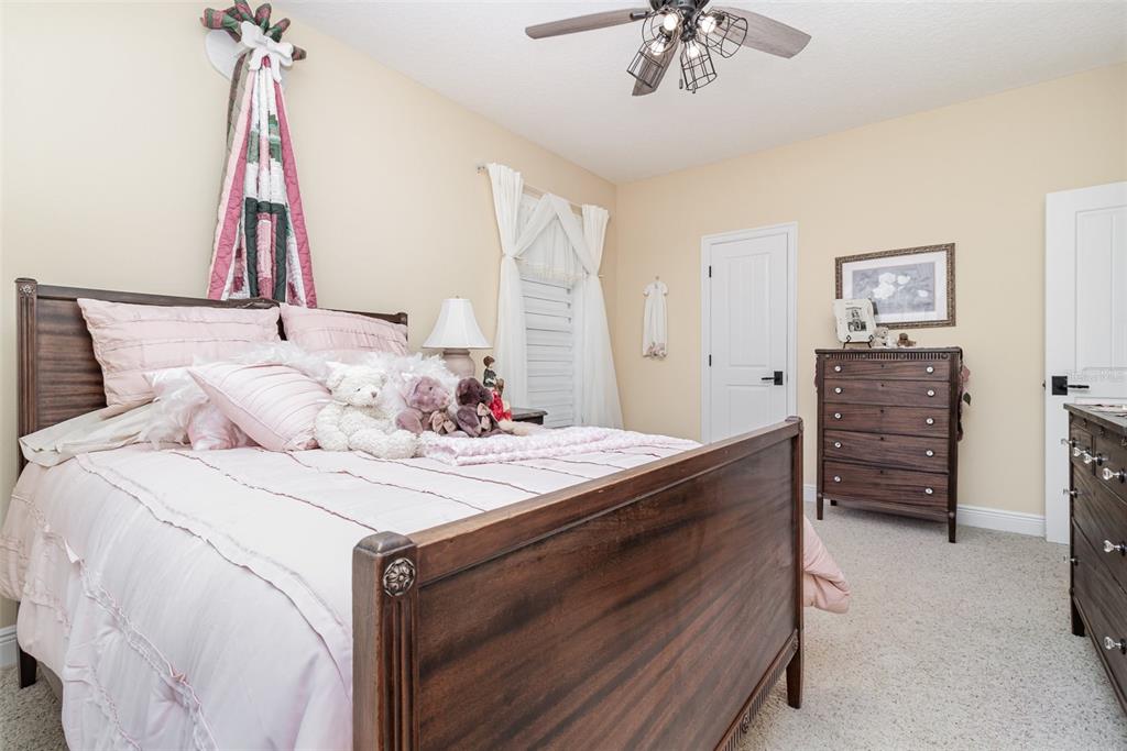 404 Long And Winding Road Howey-in-the-Hills, FL 34737 - Photo 33 of 48 a bedroom with a bed and a chandelier