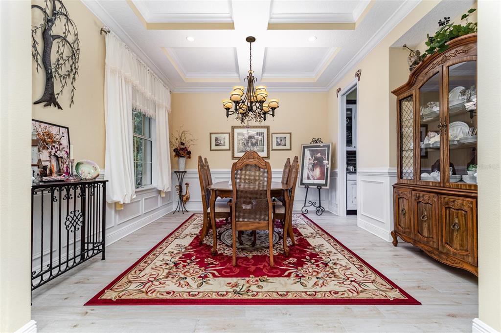 404 Long And Winding Road Howey-in-the-Hills, FL 34737 - Photo 7 of 48 a living room with dining table a rug and a chandelier