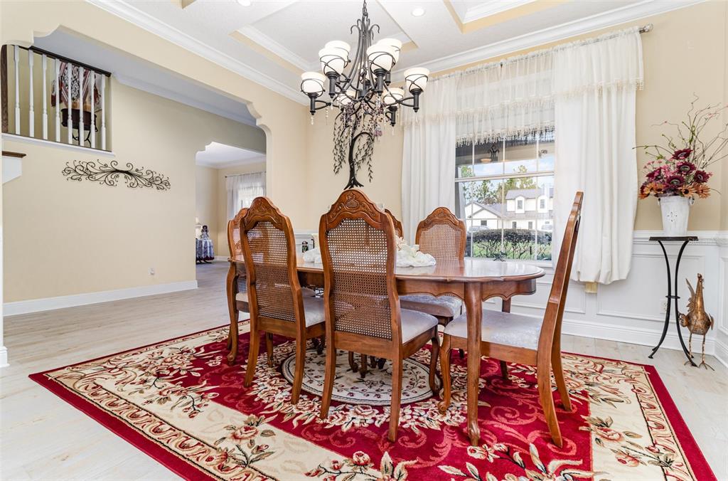 404 Long And Winding Road Howey-in-the-Hills, FL 34737 - Photo 8 of 48 a view of a dining room with furniture and chandelier