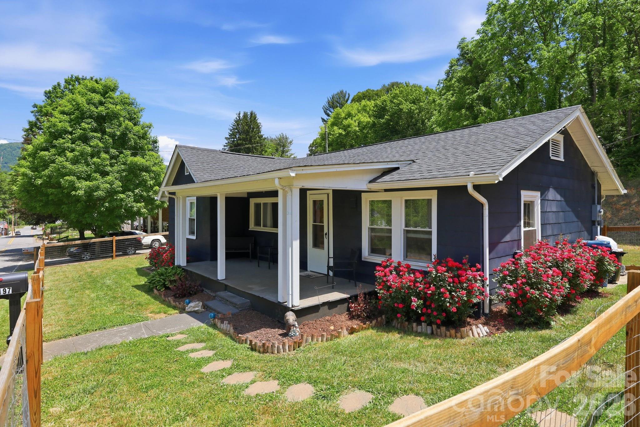 197 Mulberry Street Clyde, NC 28721 - Photo 23 of 31 a view of a house with a yard and garden