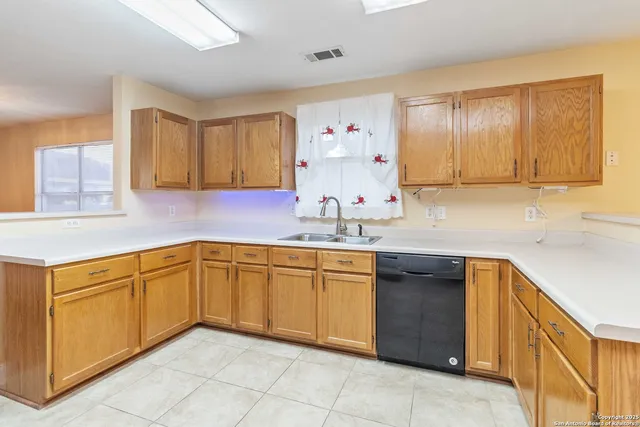 a kitchen with granite countertop sink and cabinets