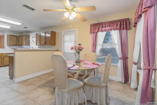 a dining room with furniture and window