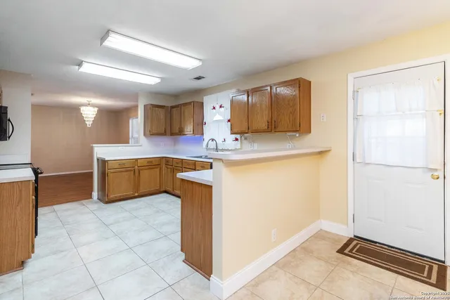 a kitchen with a sink a stove and cabinets