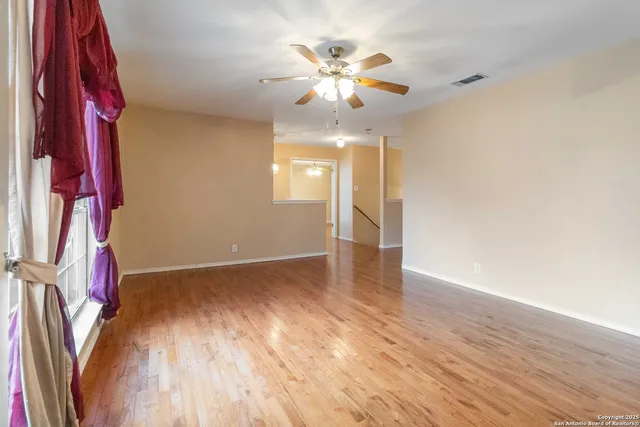 wooden floor in an empty room with a window