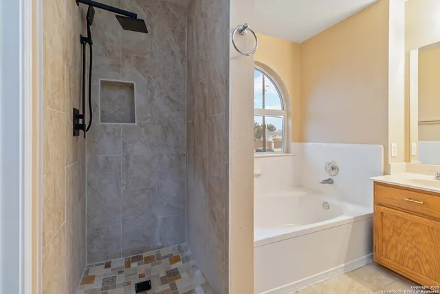 a bathroom with a bathtub and shower