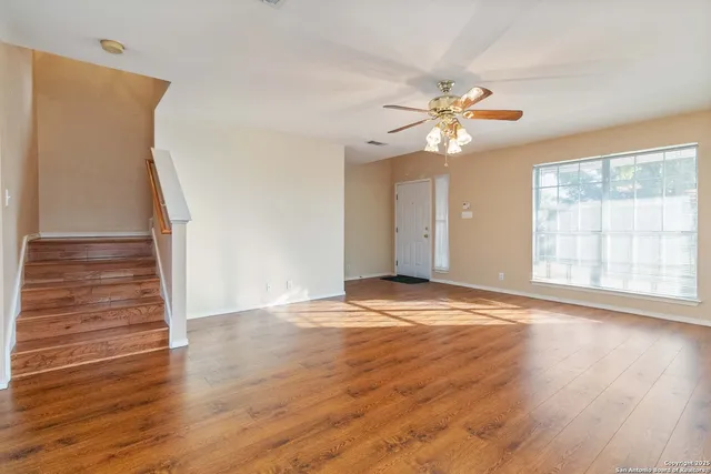 wooden floor in an empty room with a window