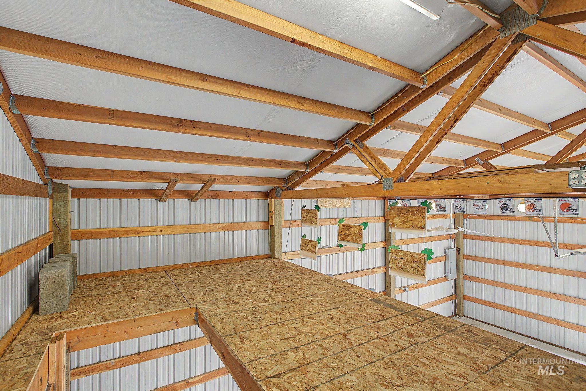 3314 6th Street Lewiston, ID 83501 - Photo 46 of 50 Spacious outbuilding interior featuring exposed wood beams, a partial loft, and corrugated metal wall panels