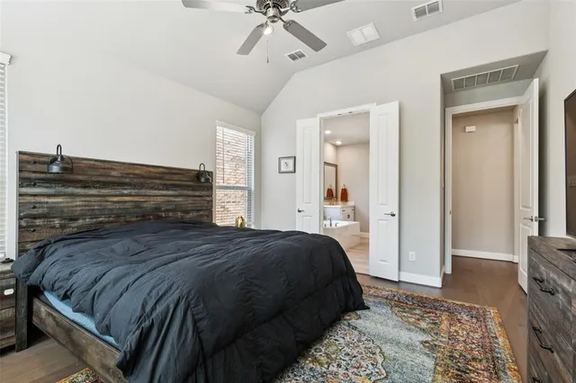 a spacious bathroom with a bathtub sink and mirror