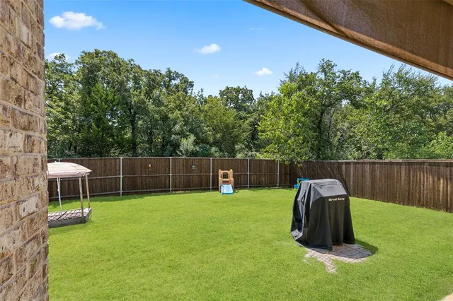 a backyard of a house with table and chairs