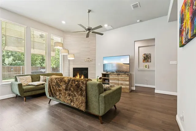 a living room with furniture a large window and a fireplace