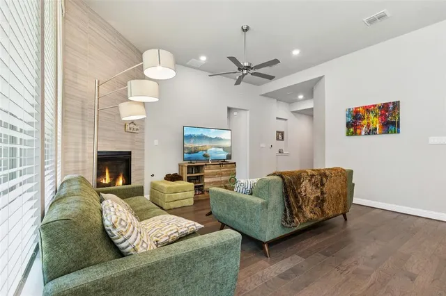 a living room with furniture fireplace and a window