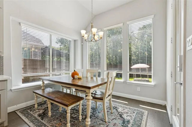 a bedroom with a bed next to a window with a chandelier