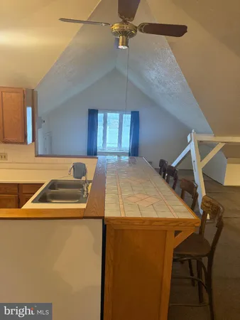 a kitchen with a table chairs refrigerator and cabinets