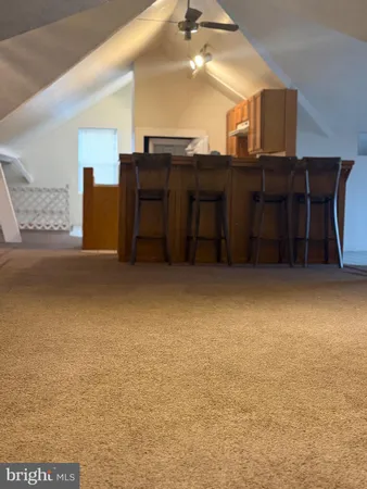 a living room with a table chairs and a dresser