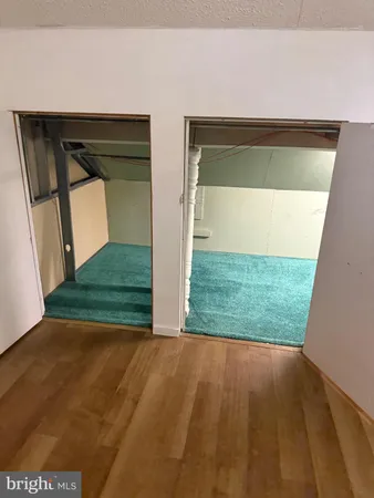 a view of a livingroom with an empty space and a window