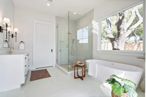a spacious bathroom with a tub shower and sink