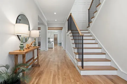 a view of entryway and hall with wooden floor