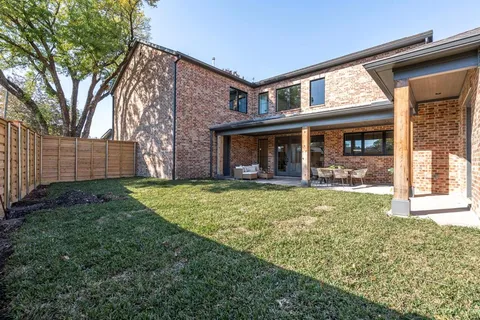 front view of a brick house with a yard