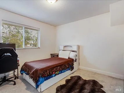 a bedroom with a bed a table and chair