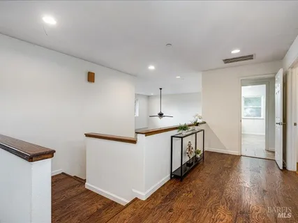 a kitchen with stainless steel appliances a white stove top oven and a wooden floors