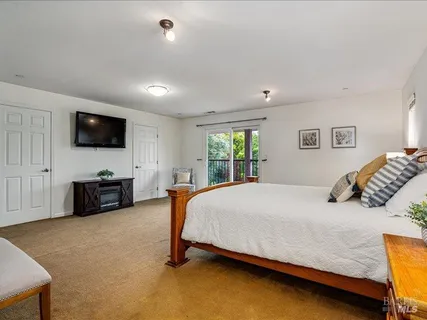 a bedroom with a bed and a flat screen tv