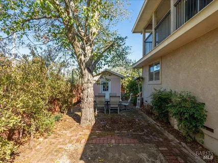 a view of a house with backyard and sitting area