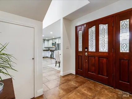 a view of a hallway with wooden floor and windows