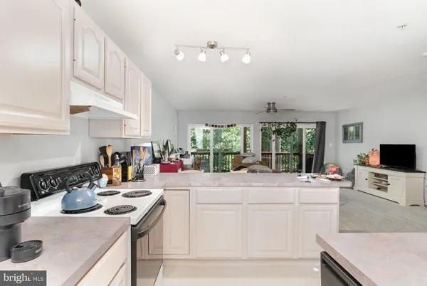 a kitchen with a stove a sink and a refrigerator