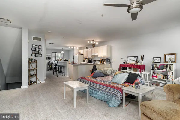 a living room with furniture and kitchen view