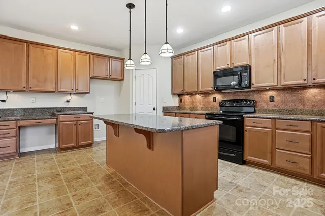 an empty room with windows and ceiling fan