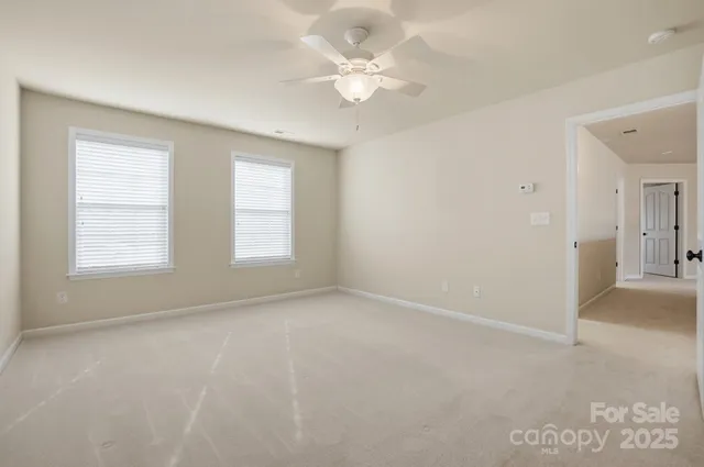 a view of an empty room with a sliding door and wooden floor