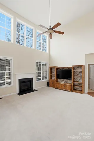 a kitchen with stainless steel appliances granite countertop a stove top oven a refrigerator a sink dishwasher a dining table and chairs with wooden floor