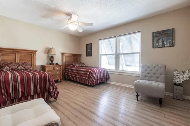 a bedroom with two beds and a chair