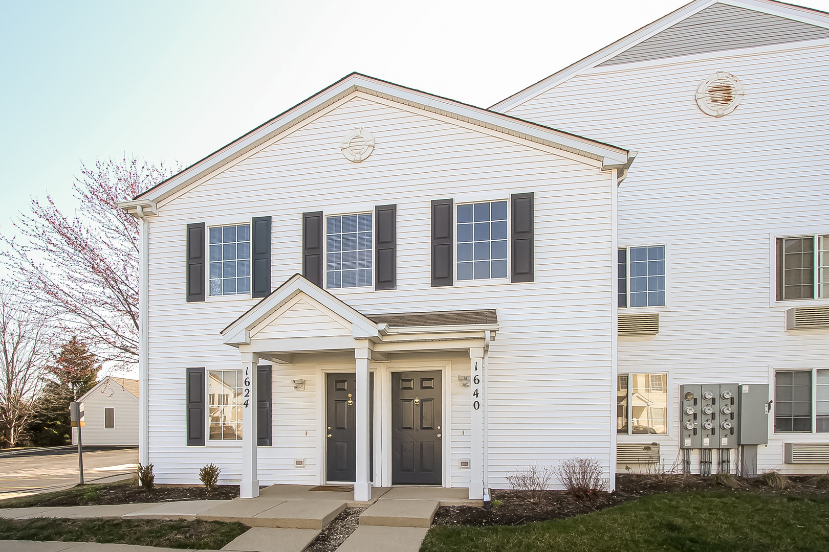 a front view of a house with a yard