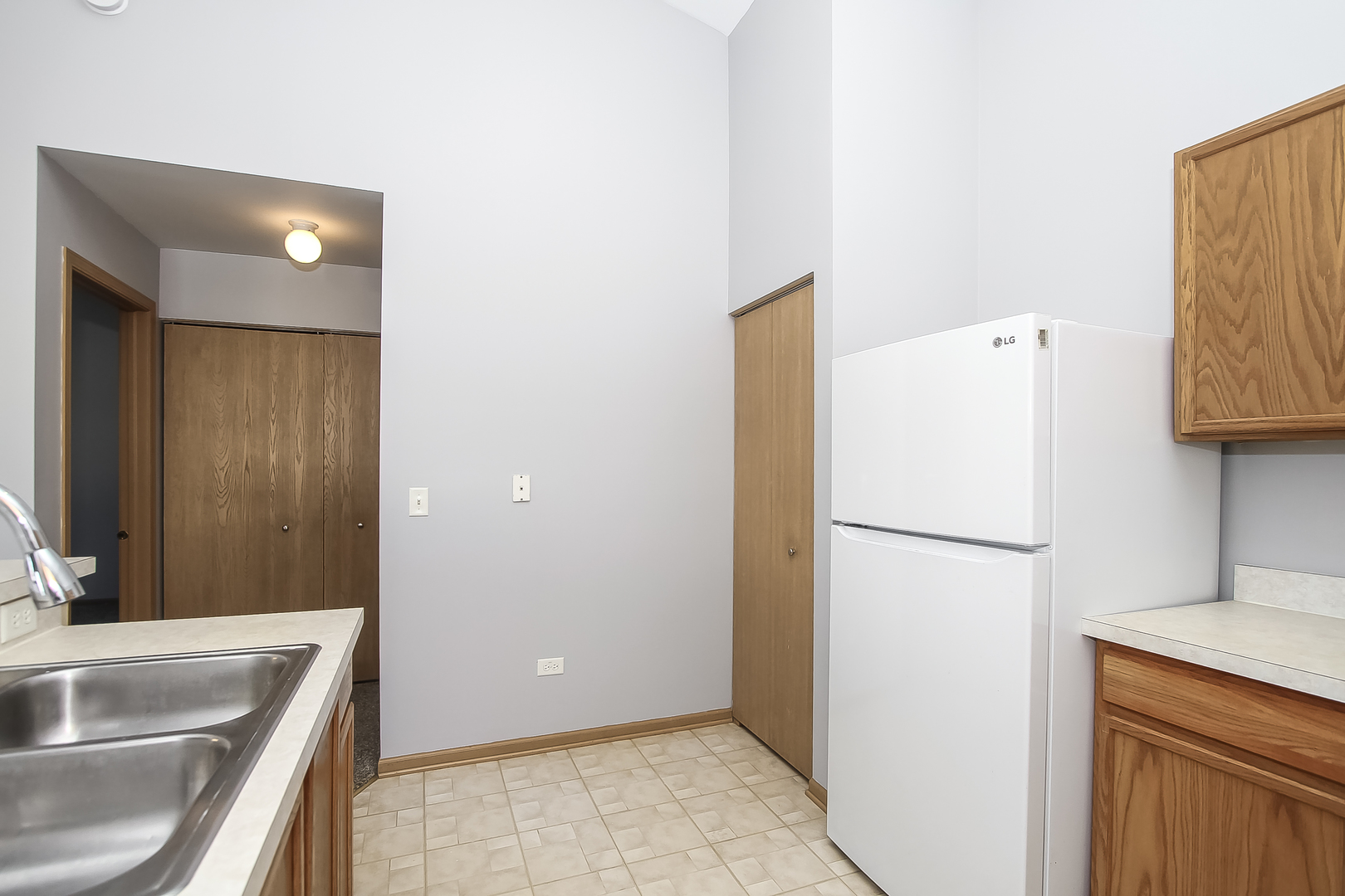 1640 McClure Road, Unit 1640 Aurora, IL 60505 - Photo 11 of 25 a white refrigerator freezer sitting inside of a kitchen