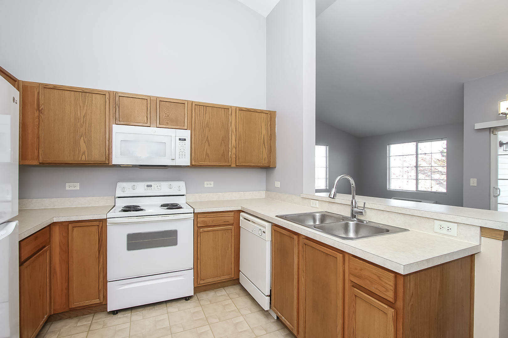 1640 McClure Road, Unit 1640 Aurora, IL 60505 - Photo 9 of 25 a kitchen with a sink stove and cabinets