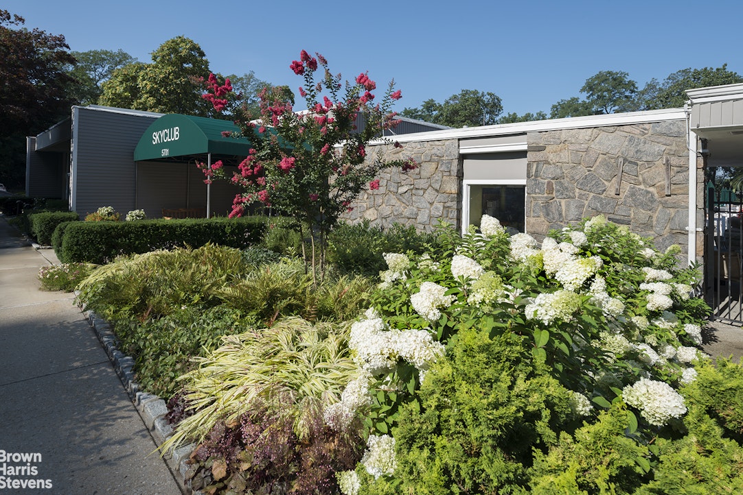 5700 Arlington Avenue, Unit 21R Bronx, NY 10471 - Photo 20 of 23 a view of a house with a flower garden