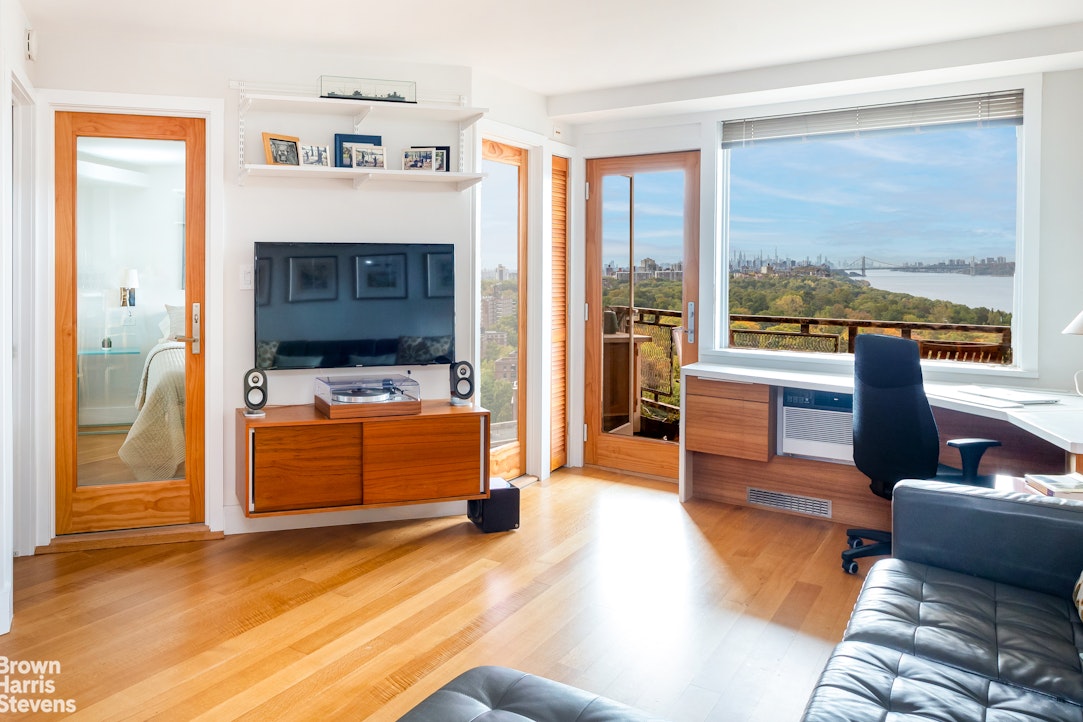 5700 Arlington Avenue, Unit 21R Bronx, NY 10471 - Photo 3 of 23 a living room with furniture and a flat screen tv