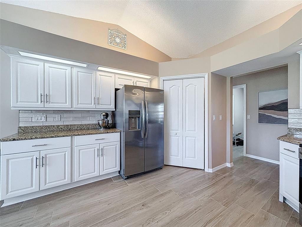 9428 Apple Dumpling Court Weeki Wachee, FL 34613 - Photo 11 of 40 a kitchen with stainless steel appliances granite countertop a refrigerator and a sink