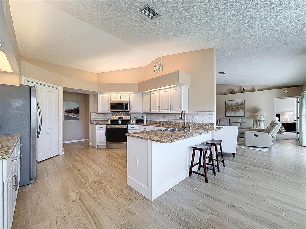 9428 Apple Dumpling Court Weeki Wachee, FL 34613 - Photo 12 of 40 a kitchen with a sink appliances and cabinets