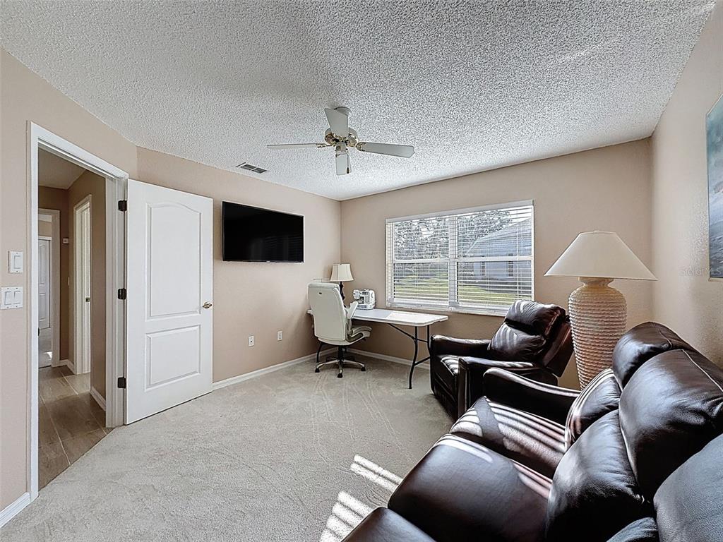 9428 Apple Dumpling Court Weeki Wachee, FL 34613 - Photo 22 of 40 a living room with furniture and a window