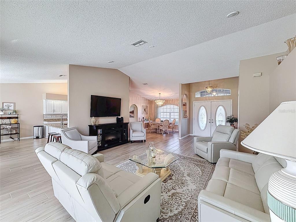 9428 Apple Dumpling Court Weeki Wachee, FL 34613 - Photo 8 of 40 a living room with furniture and a flat screen tv